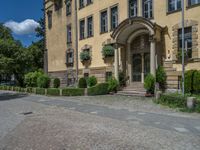 large yellow building with some plants and bushes in front of it for decoration or entertainment