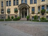 large yellow building with some plants and bushes in front of it for decoration or entertainment