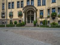 large yellow building with some plants and bushes in front of it for decoration or entertainment