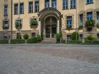 large yellow building with some plants and bushes in front of it for decoration or entertainment