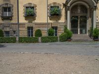 large yellow building with some plants and bushes in front of it for decoration or entertainment