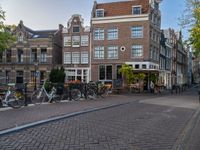 several bicycle racks sit along side a cobblestone road in the middle of a city