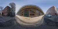 two panoramic images of a building in the city, as shown through a fisheye lens