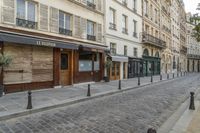 two black post's on a cobble - stone road in paris, france