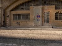 a motorcycle parked outside of an old building with graffiti on the walls and a stop sign in front