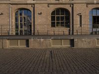 the courtyard area at this large brick building is very large and has windows with lots of light