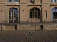 the courtyard area at this large brick building is very large and has windows with lots of light