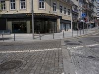a city street with an empty intersection on the corner of it and parked cars on either side