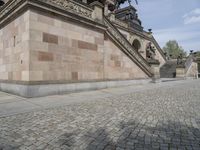 a couple of stairs with stone on it's side, in front of a building