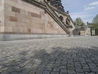 a couple of stairs with stone on it's side, in front of a building