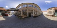 a 360 - view of a building and some other buildings on the street while you can see