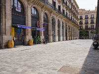 a cobblestone street in an european city on a sunny day with pedestrians on the sidewalk