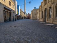 Cobblestone Street in Berlin: Classic Architecture and Hard Shadows