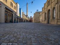 Cobblestone Street in Berlin: Classic Architecture and Hard Shadows