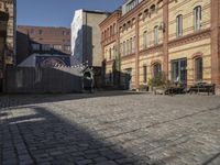 a cobblestone street in front of an old building on a sunny day,