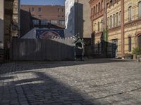 a cobblestone street in front of an old building on a sunny day,