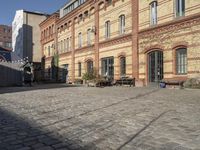 a cobblestone street in front of an old building on a sunny day,