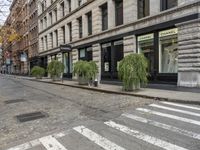 a cobblestone street and some buildings are shown at the intersection of two roads