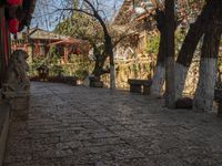 a street with stone steps, old buildings and a stone bench under an overhang