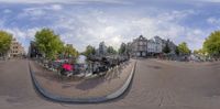 a fish eye lens view of the street where people walk, bike and bike are