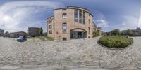 an image of a big building on the street that is taken from 360 - view