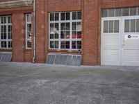 a red fire hydrant in front of a building next to an open door to a store