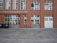 a red fire hydrant in front of a building next to an open door to a store