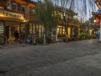 Cobblestone Streets at Dawn: Yellow Lights and Cafes