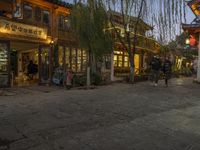 Cobblestone Streets at Dawn: Yellow Lights and Cafes