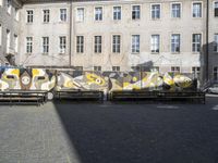 Cobblestone Streets with Graffiti Wall: Urban Design