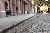 the cobblestone streets of new york are lined with historic stone buildings in new york city