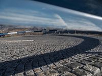 a cobblestone walkway leads to a parking space for the skiers to go skiing