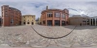 a 360 - spherical view of a building in the city with cobblestone walkway and stone pavement