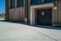 a door and door to the building on the side of the street with a fire hydrant outside