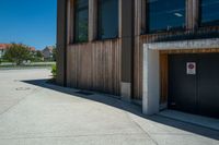 a door and door to the building on the side of the street with a fire hydrant outside