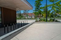 a skateboard that is in the middle of a sidewalk near some trees and buildings