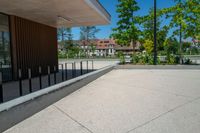 a skateboard that is in the middle of a sidewalk near some trees and buildings