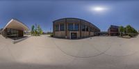 a fish eye lens lensing out on two buildings and a clock in front of them