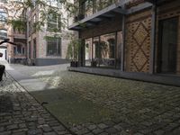 two bikes parked next to each other near a building on a cobblestone street