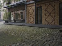 two bikes parked next to each other near a building on a cobblestone street