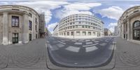 multiple panoramic lens pictures with an oval shape building and a street lined in empty spaces