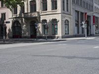 a red stop sign sitting on the side of the road near a building in front of a building