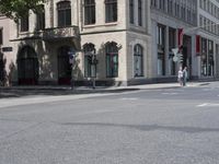 a red stop sign sitting on the side of the road near a building in front of a building