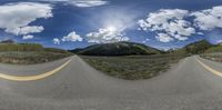 two wide shot lens panoramas of an empty mountain highway next to mountains and trees