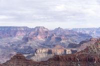 the canyon is surrounded by rocks and trees in its barren area of land with cloudy sky