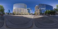 a distorted image of some buildings and a bench by the sidewalk with a man sitting on the ground in front of them