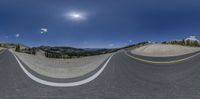 a 360 - view photograph shows a mountain range and road at dusk, with a bright moon above the mountains