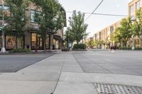 a street with buildings along it and a bench on the sidewalk near the side walk