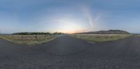 a virtual photo of the sun setting over a field with a road stretching out into the distance