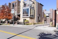 a residential building is on the corner of this street, with some trees in the background